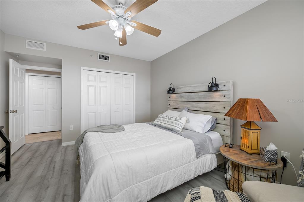 960 Starkey Road, Unit 5504 Largo, FL 33771 - Photo 37 of 46 a bedroom with a bed and a chandelier