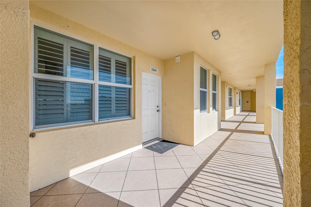 960 Starkey Road, Unit 5504 Largo, FL 33771 - Photo 6 of 46 a view of a porch with wooden floor and a rug