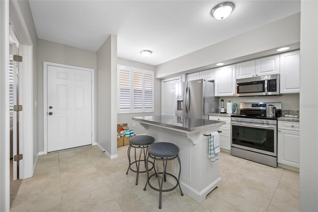 960 Starkey Road, Unit 5504 Largo, FL 33771 - Photo 8 of 46 a kitchen with stainless steel appliances a stove a sink refrigerator and microwave