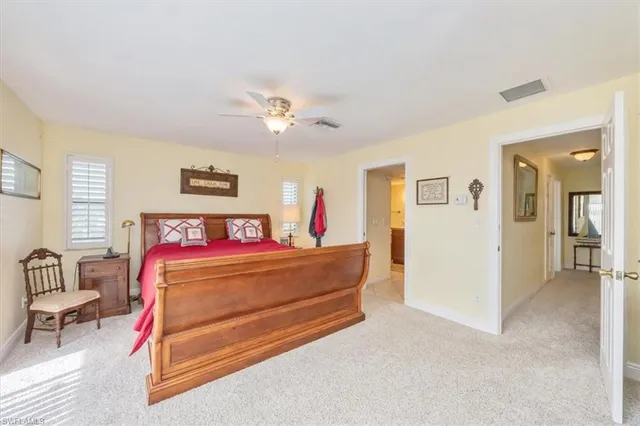 a bedroom with furniture and a chandelier