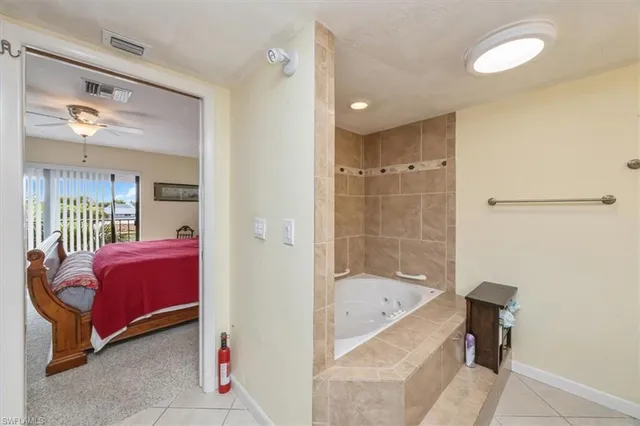 a bathroom with a tub shower and sink