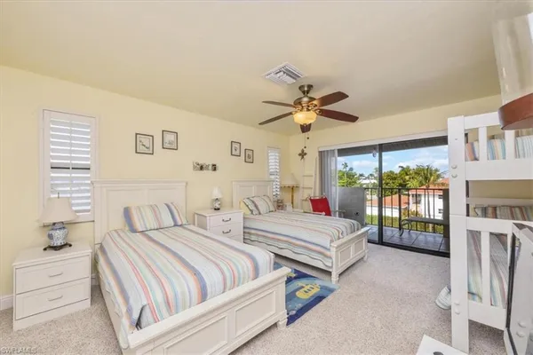 a spacious bedroom with two beds and a chandelier