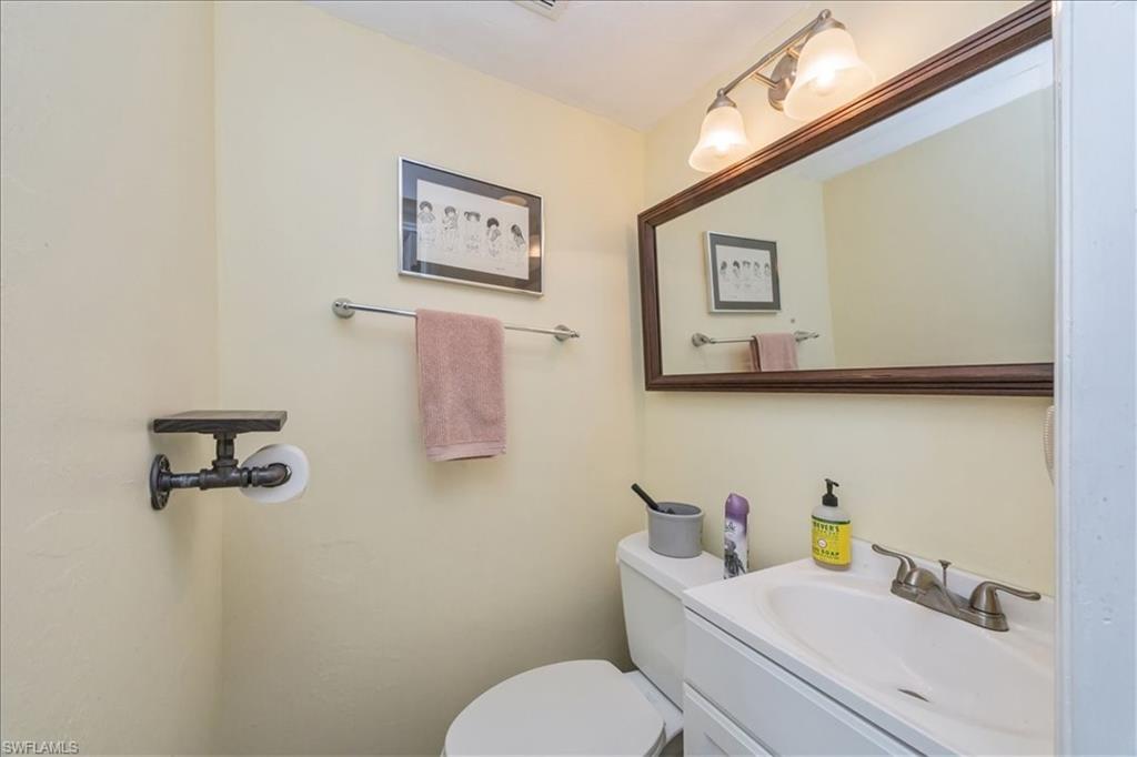 1400 Blue Point Avenue, Unit 208 Naples, FL 34102 - Photo 19 of 24 a bathroom with a toilet sink and mirror