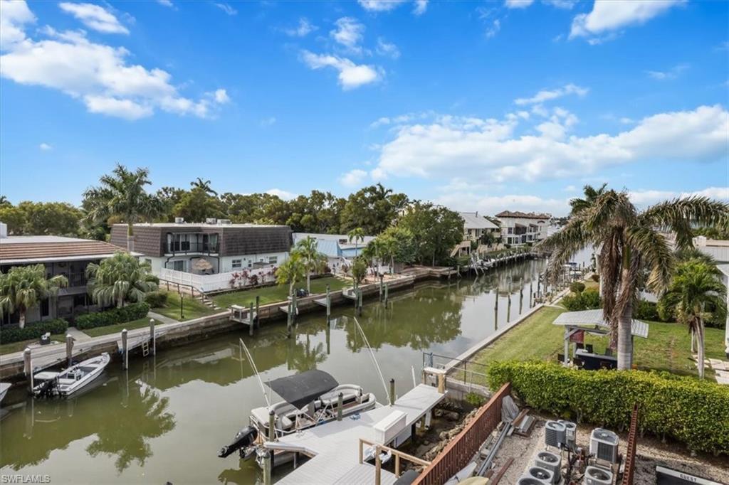 1400 Blue Point Avenue, Unit 208 Naples, FL 34102 - Photo 23 of 24 a view of a lake with a city