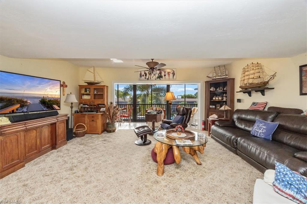 1400 Blue Point Avenue, Unit 208 Naples, FL 34102 - Photo 6 of 24 a living room with furniture and a flat screen tv