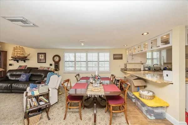 a dining room with furniture and a large window