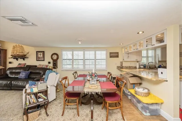 a dining room with furniture and a large window