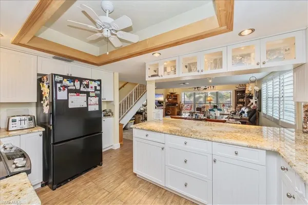 a kitchen with stainless steel appliances granite countertop a refrigerator a stove and a sink