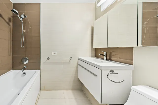 a bathroom with a sink a toilet and bathtub