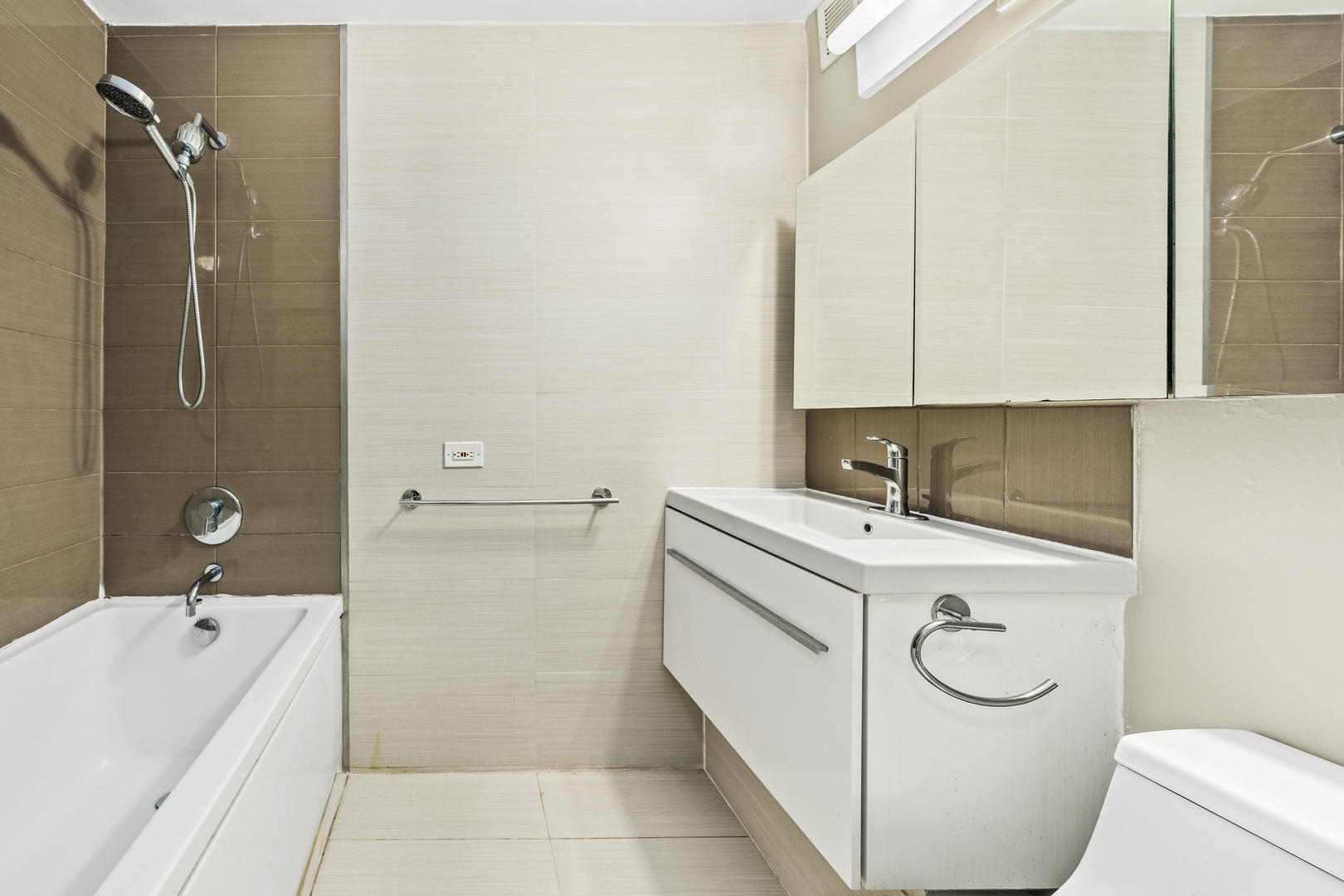 1540 North LaSalle Street, Unit 907 Chicago, IL 60610 - Photo 12 of 16 a bathroom with a sink a toilet and bathtub