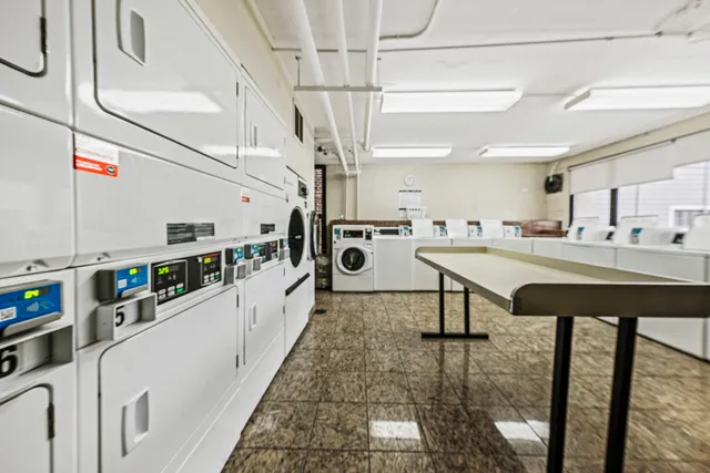 a kitchen with stainless steel appliances kitchen island granite countertop a sink and cabinets