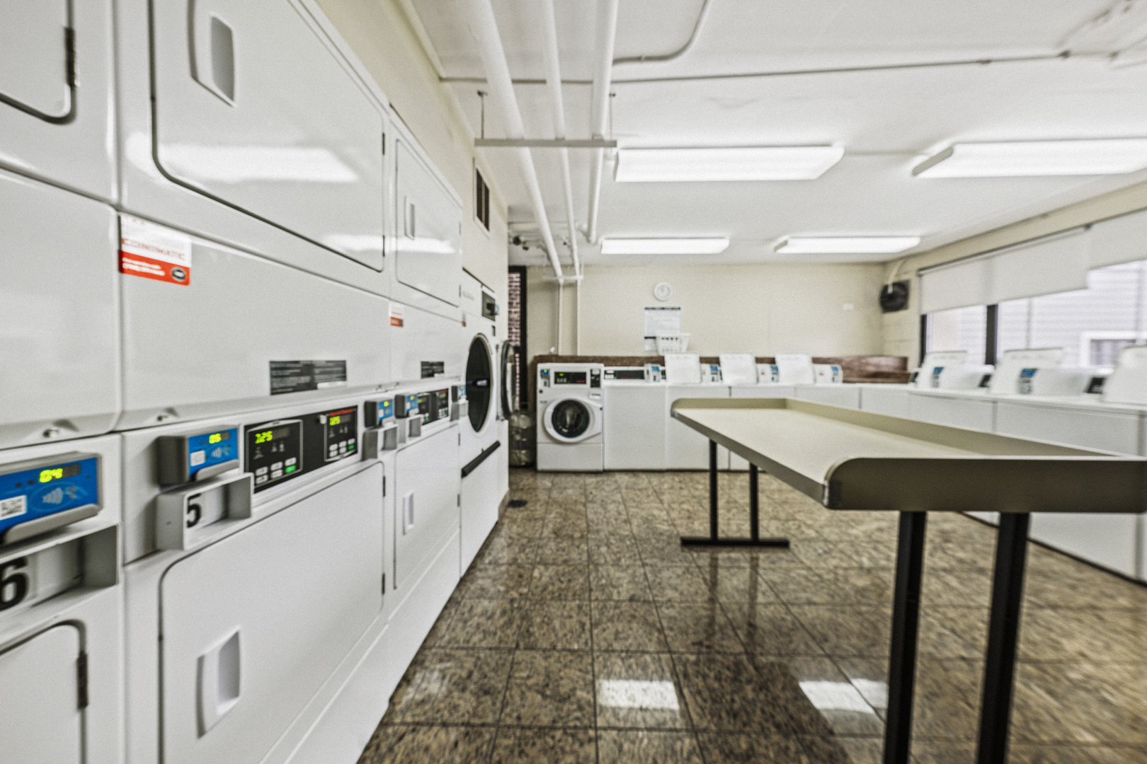 1540 North LaSalle Street, Unit 907 Chicago, IL 60610 - Photo 13 of 16 a kitchen with stainless steel appliances kitchen island granite countertop a sink and cabinets