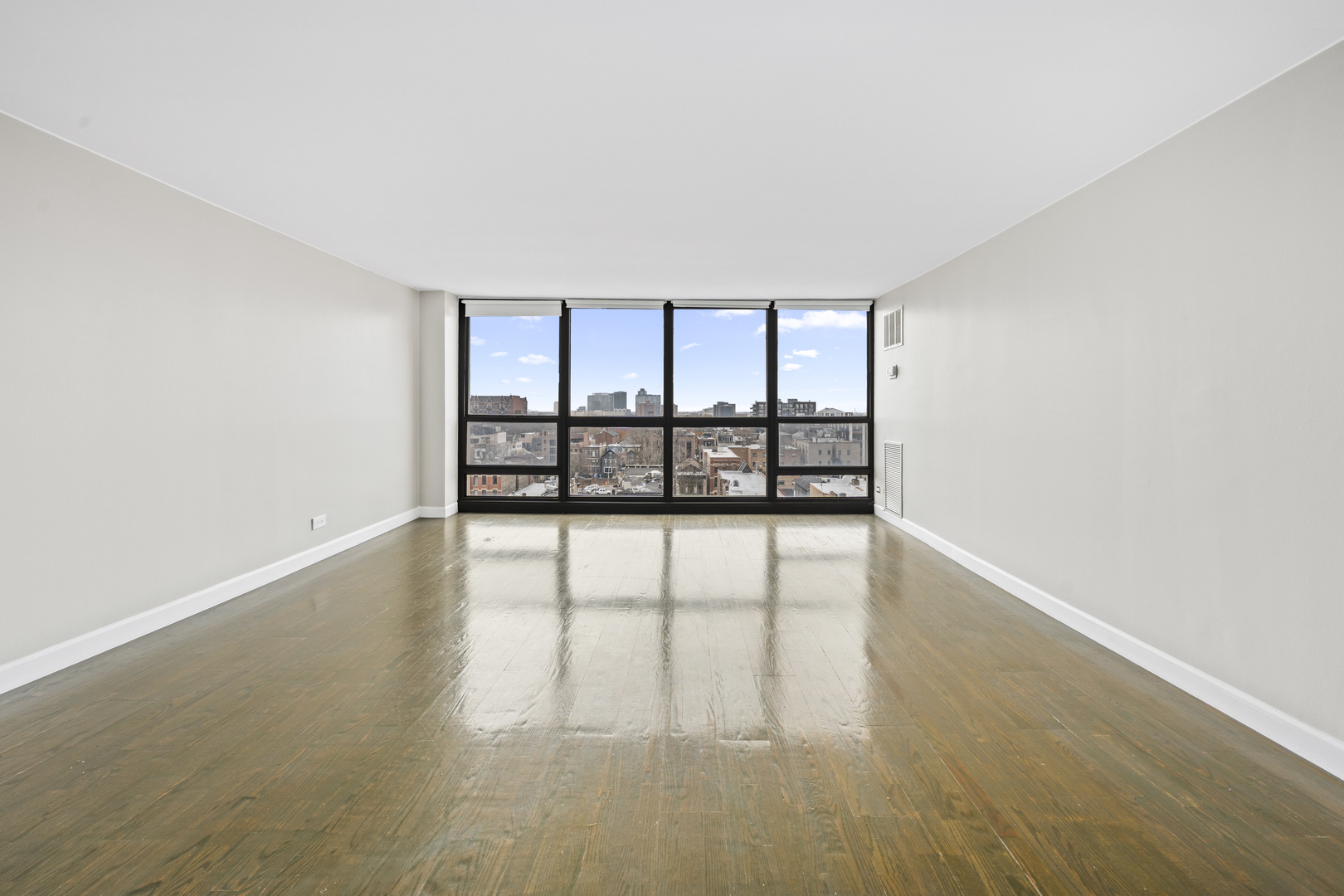 1540 North LaSalle Street, Unit 907 Chicago, IL 60610 - Photo 4 of 16 wooden floor in an empty room with a window