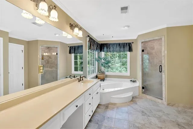 a spacious bathroom with a large tub shower and sink