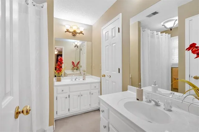 a bathroom with a sink vanity and mirror