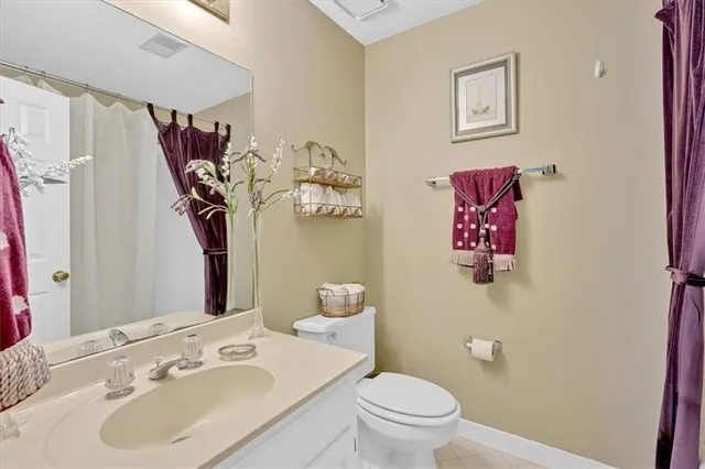 a bathroom with a sink mirror vanity and toilet