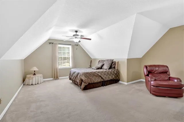 a spacious bedroom with a bed and dresser