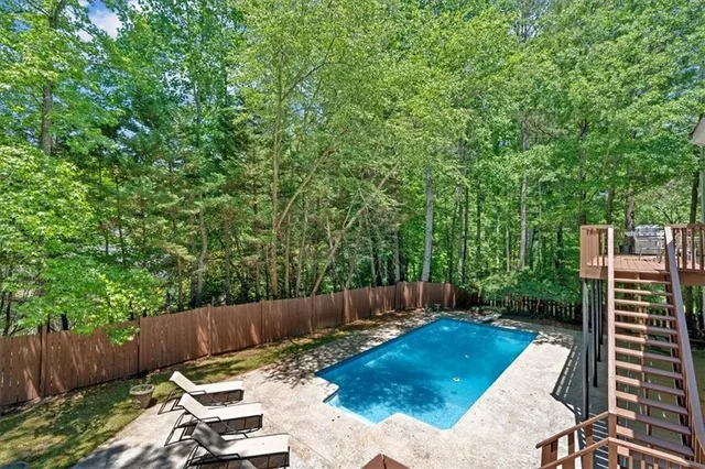 a view of backyard with furniture and wooden fence