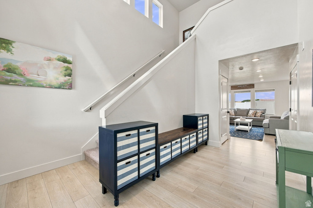 1566 Silver Canoe Loop Logan, UT 84321 - Photo 13 of 44 Two-story entry with wood-finish flooring, white walls, and a staircase featuring a white railing