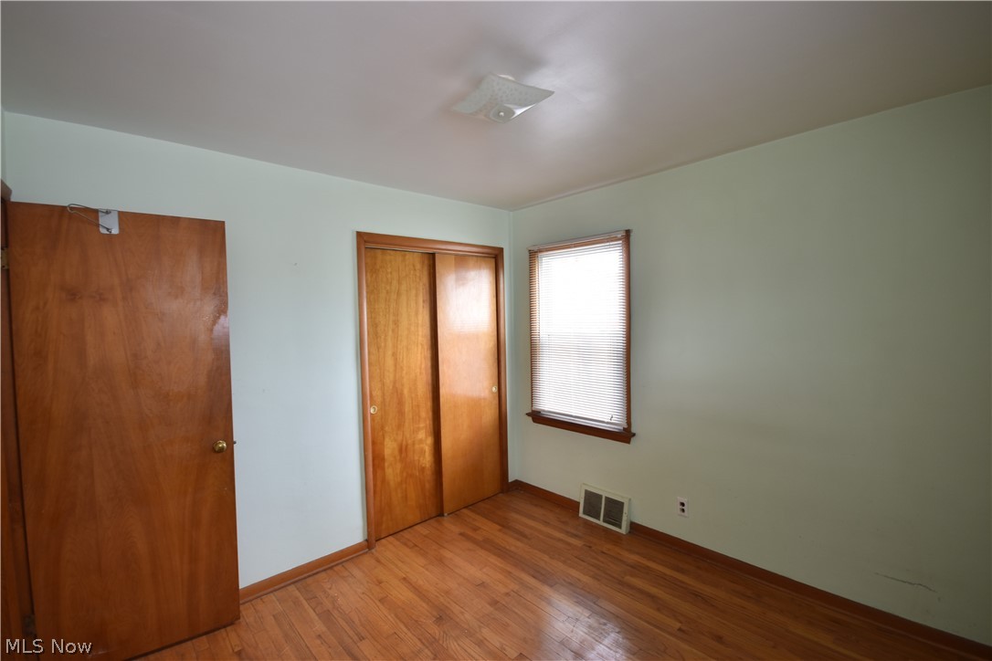 31921 Pendley Road Willowick, OH 44095 - Photo 17 of 22 Unfurnished bedroom with a closet and hardwood / wood-style flooring