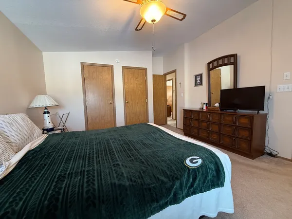 a bedroom with a bed and a television