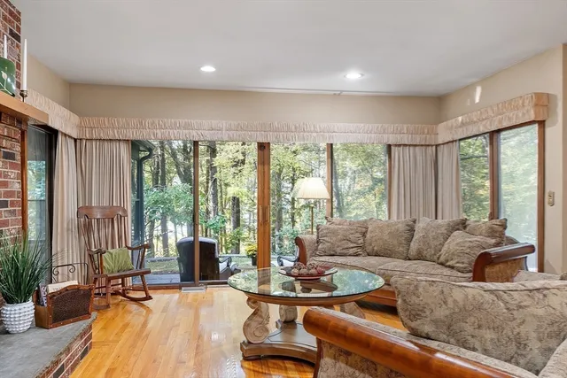 a living room with furniture and large windows