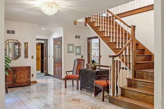 a view of hall way with furniture and staircase