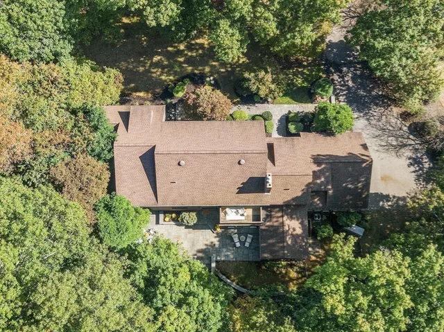an aerial view of a house with yard and outdoor seating