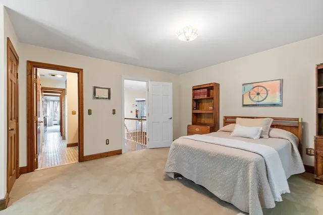 a bedroom with a large bed and a chandelier