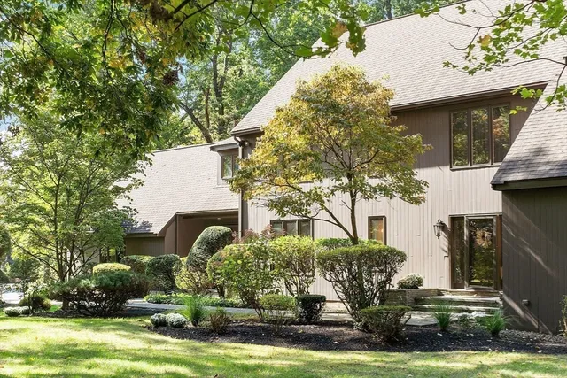 a front view of a house with lots of trees