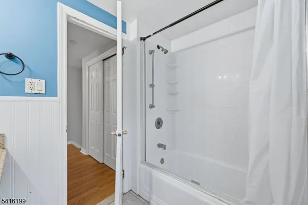 a bathroom with a bathtub and a shower
