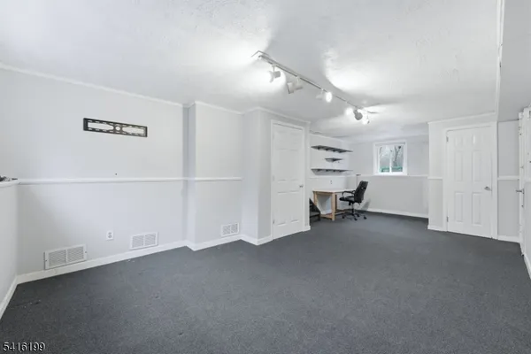 a view of an empty room with a fireplace