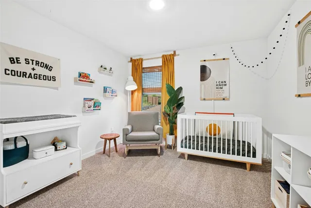 a bedroom with furniture and white walls