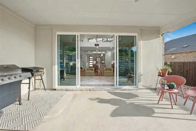 a bedroom with a bed and large windows