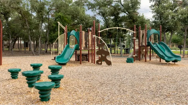 a childrens park with lots of trees and plants