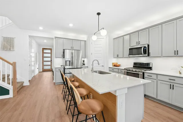 a kitchen with a table chairs and cabinets