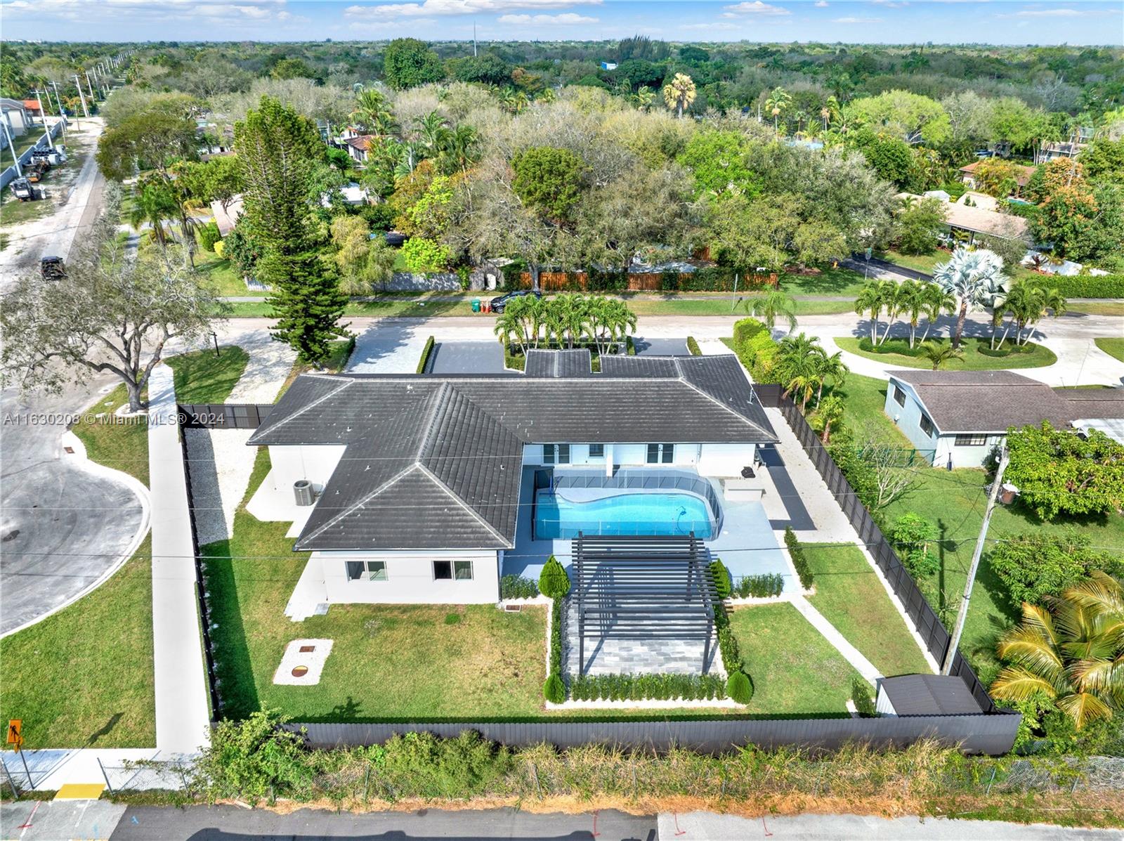 an aerial view of a house with a yard basket ball court and outdoor seating