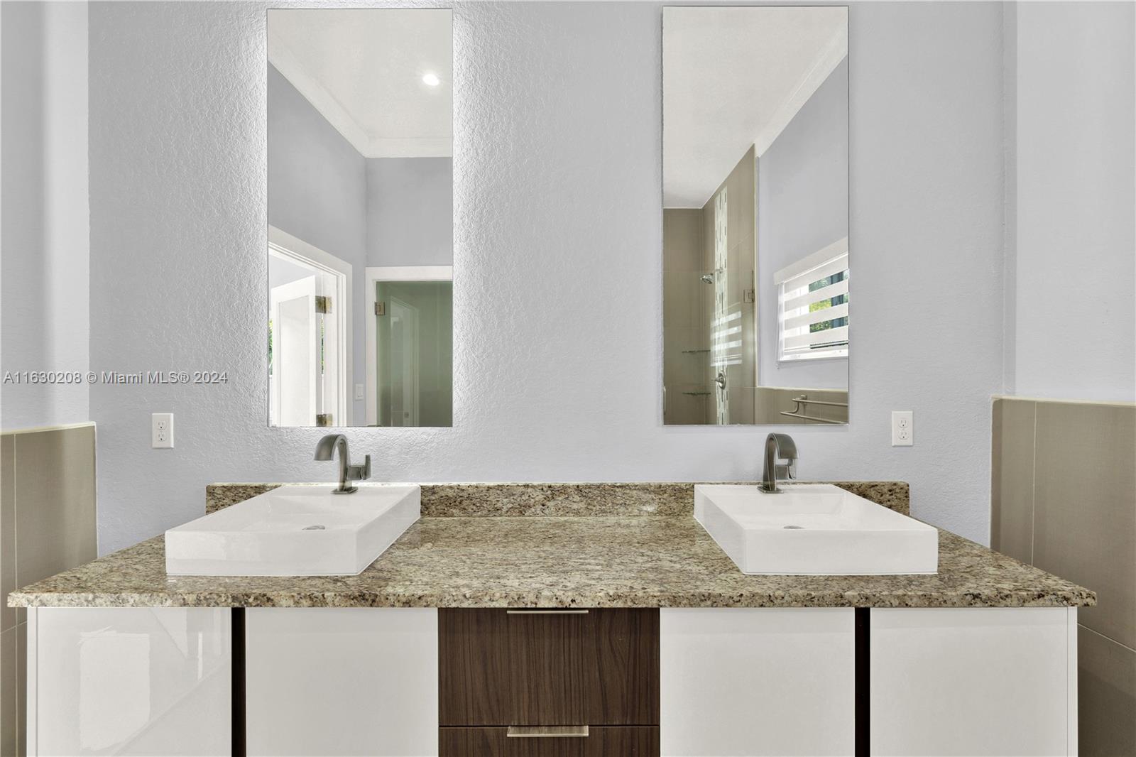 11921 Southwest 82nd Road Miami, FL 33156 - Photo 15 of 32 a bathroom with a granite countertop sink and a mirror