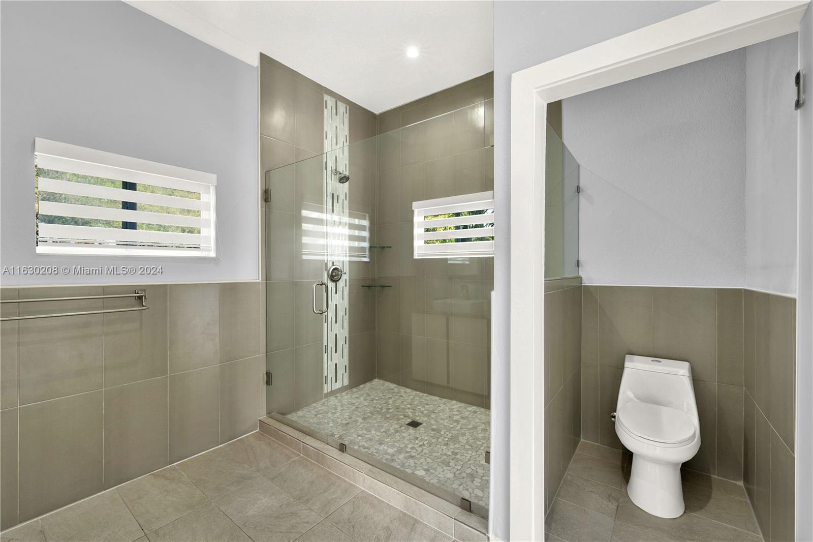 11921 Southwest 82nd Road Miami, FL 33156 - Photo 16 of 32 a bathroom with a toilet sink and shower