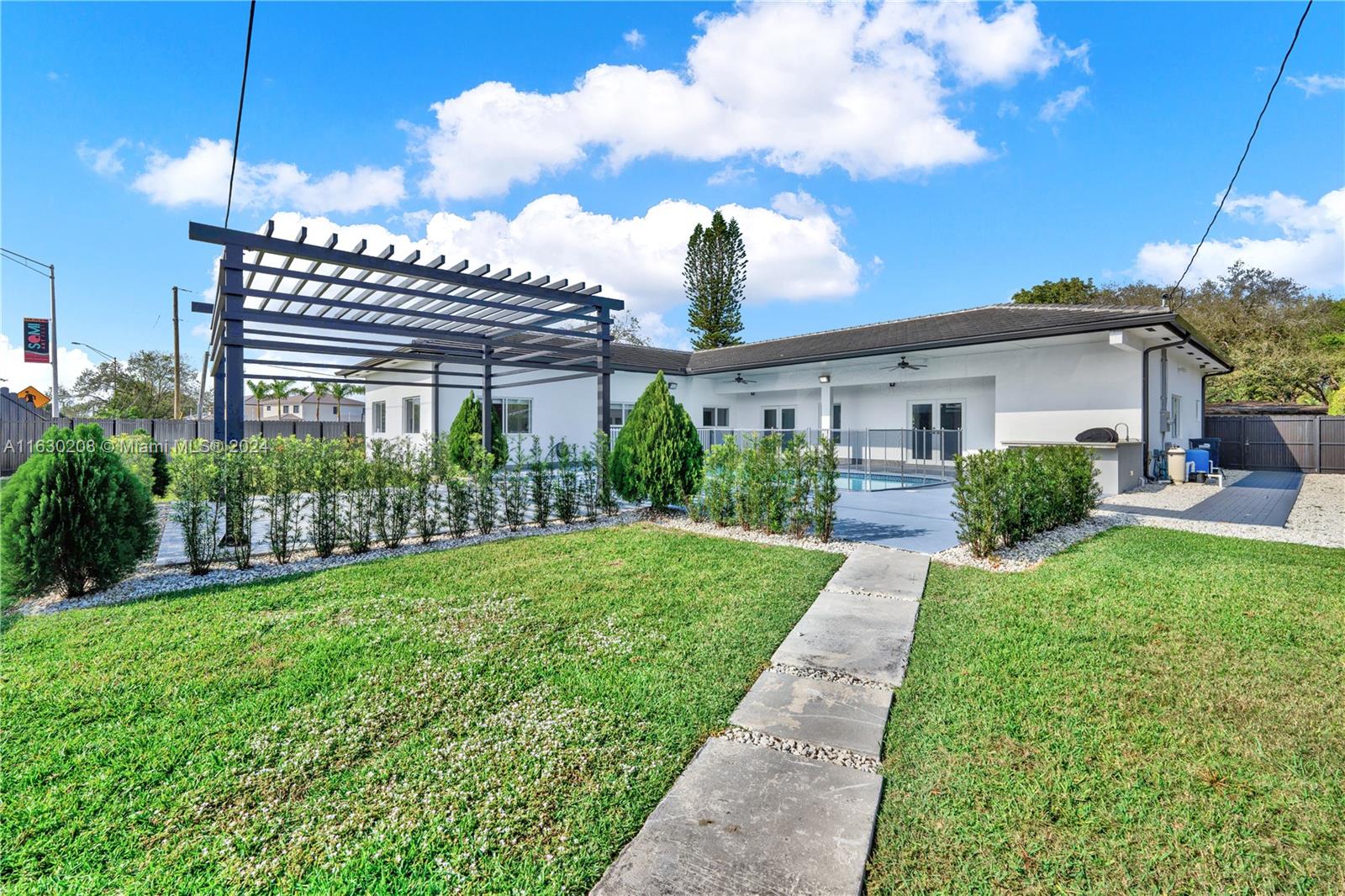 11921 Southwest 82nd Road Miami, FL 33156 - Photo 20 of 32 a view of a house with a yard