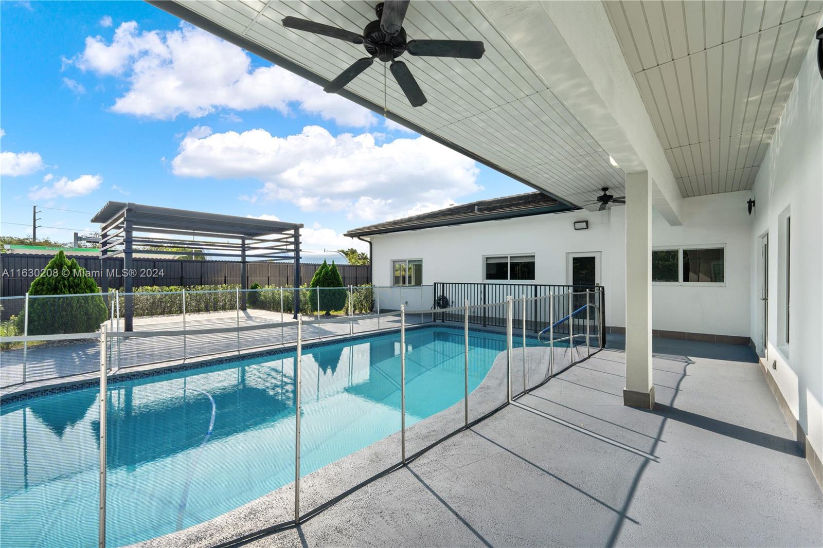 11921 Southwest 82nd Road Miami, FL 33156 - Photo 25 of 32 a view of a house with backyard and porch