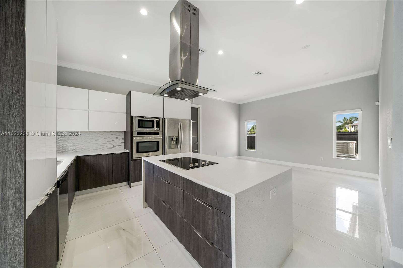 11921 Southwest 82nd Road Miami, FL 33156 - Photo 10 of 32 a kitchen with a stove a refrigerator and a sink