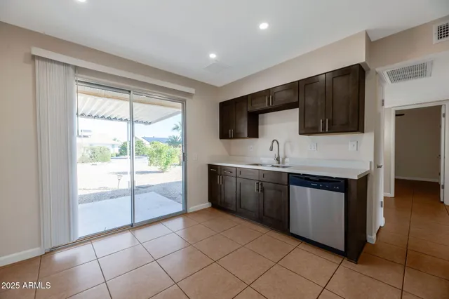 a kitchen with stainless steel appliances granite countertop a refrigerator and a sink