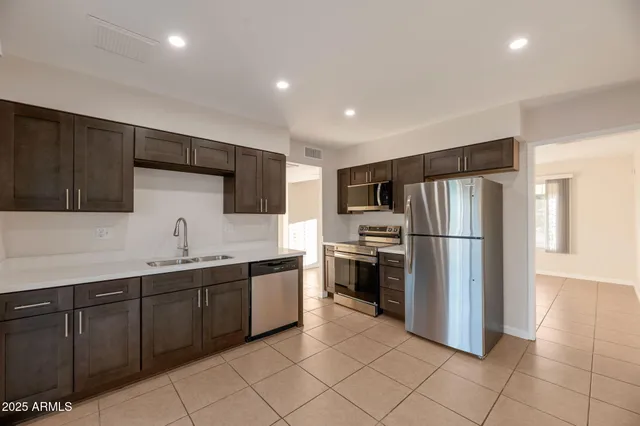 a kitchen with stainless steel appliances a refrigerator and a sink