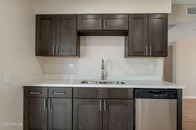a kitchen with a sink and cabinets