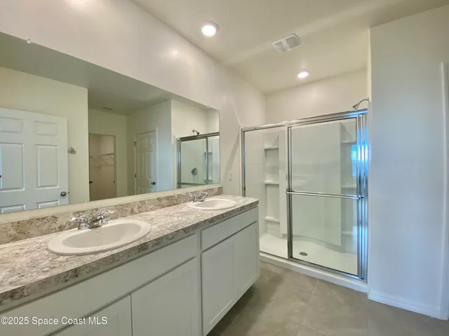a bathroom with a granite countertop sink mirror and double