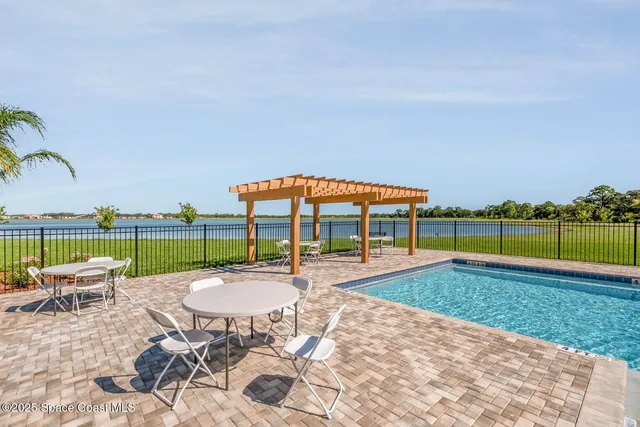 a view of a swimming pool and lounge chairs