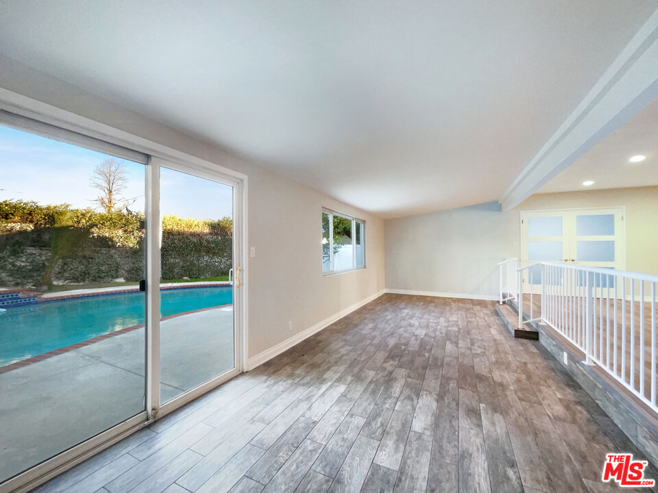 7944 Limerick Avenue Winnetka, CA 91306 - Photo 11 of 23 wooden floor in an empty room with a window