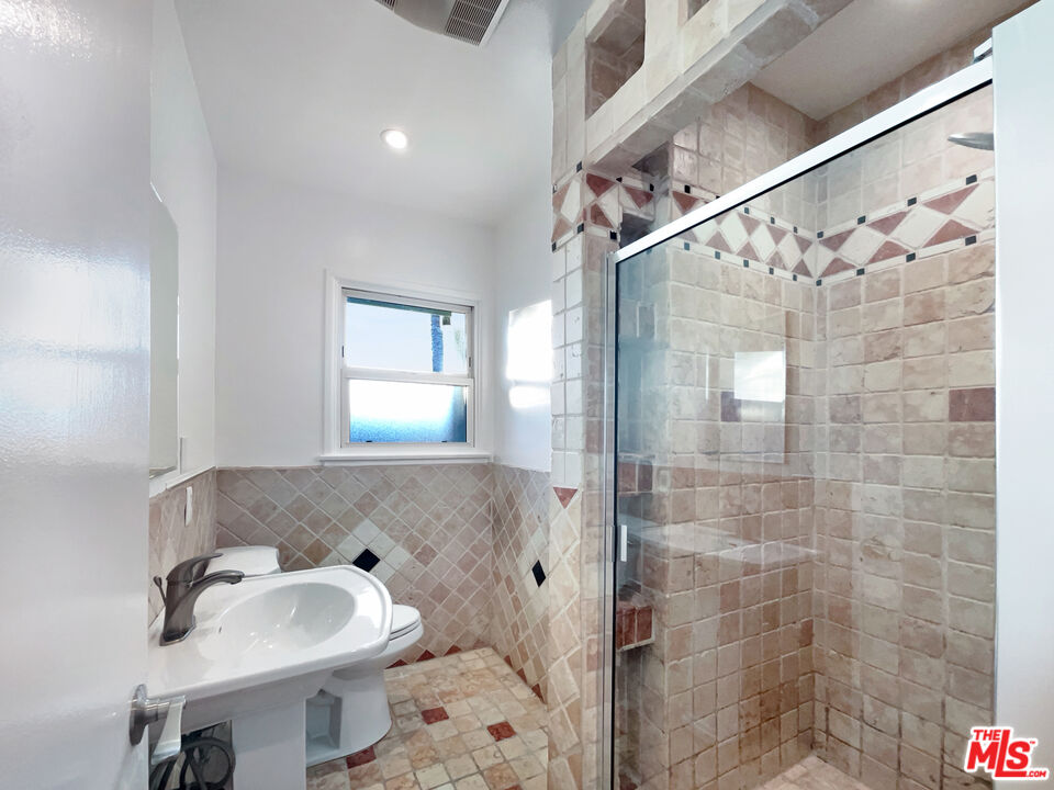 7944 Limerick Avenue Winnetka, CA 91306 - Photo 15 of 23 a bathroom with a sink toilet and shower