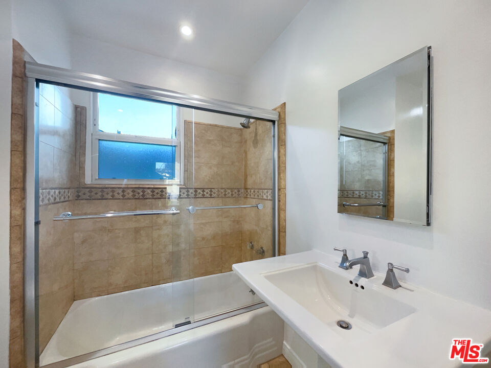 7944 Limerick Avenue Winnetka, CA 91306 - Photo 16 of 23 a bathroom with a sink and a mirror